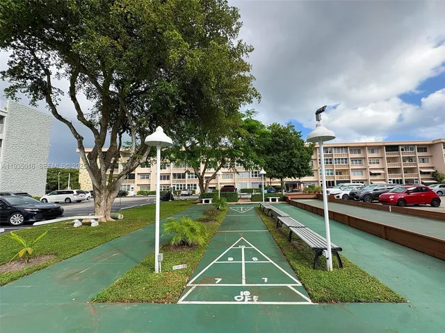 a living room with furniture a chandelier and a window