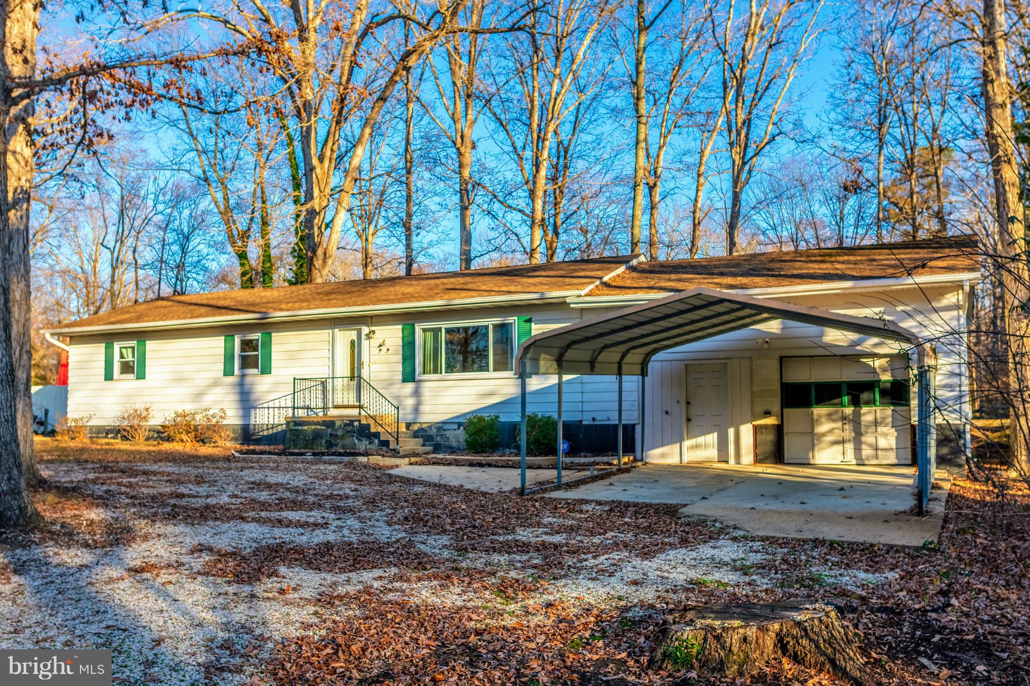 12820 Rousby Hall Road Lusby, MD 20657 - Photo 1 of 39 a front view of a house with garden