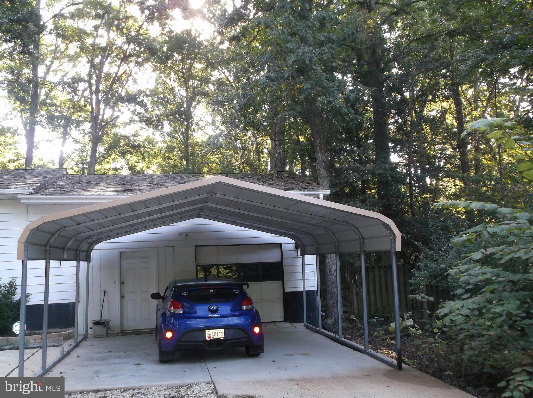 12820 Rousby Hall Road Lusby, MD 20657 - Photo 2 of 39 a car parked in front of a house
