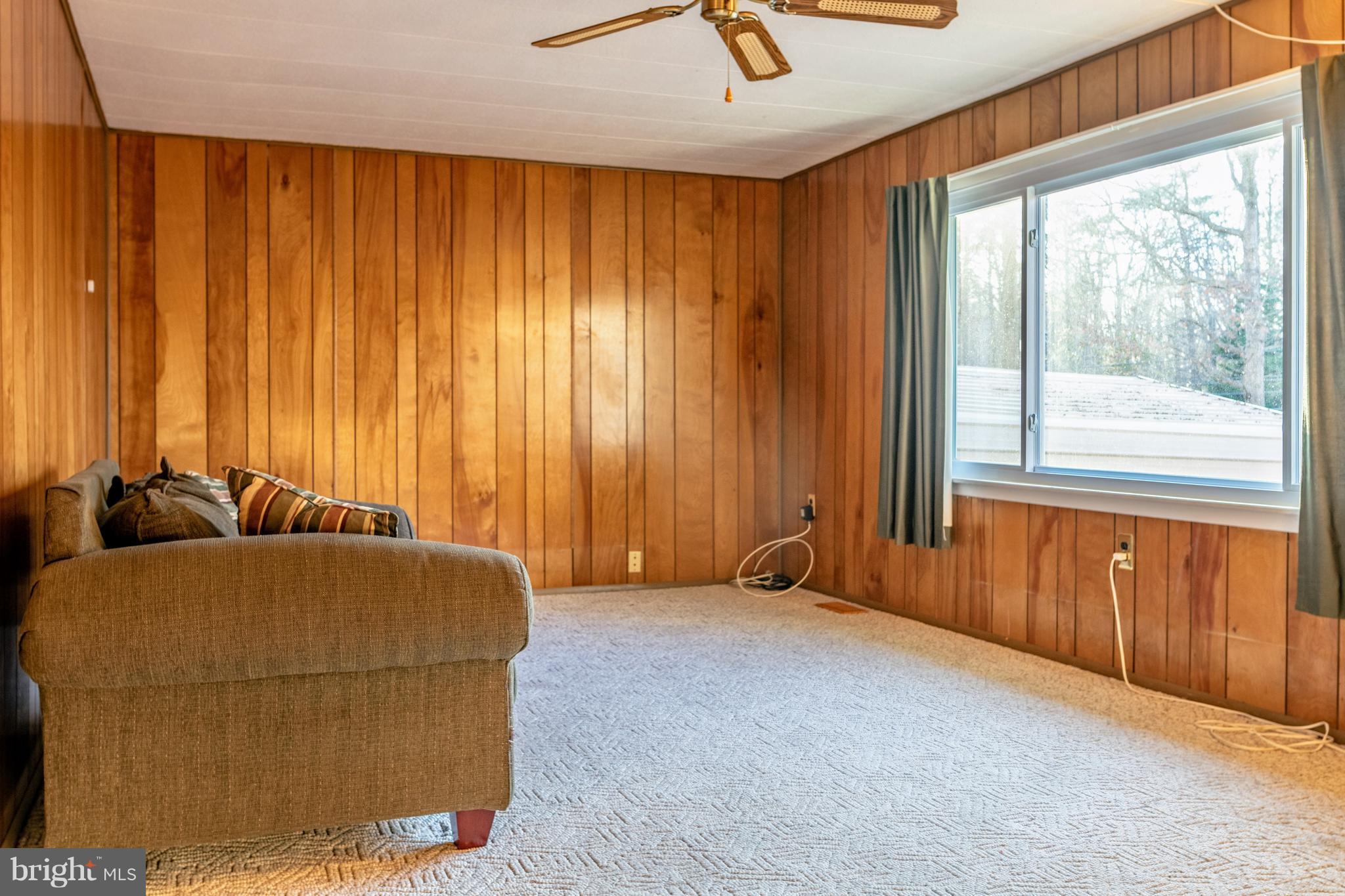 12820 Rousby Hall Road Lusby, MD 20657 - Photo 11 of 39 a bedroom with a bed and a window