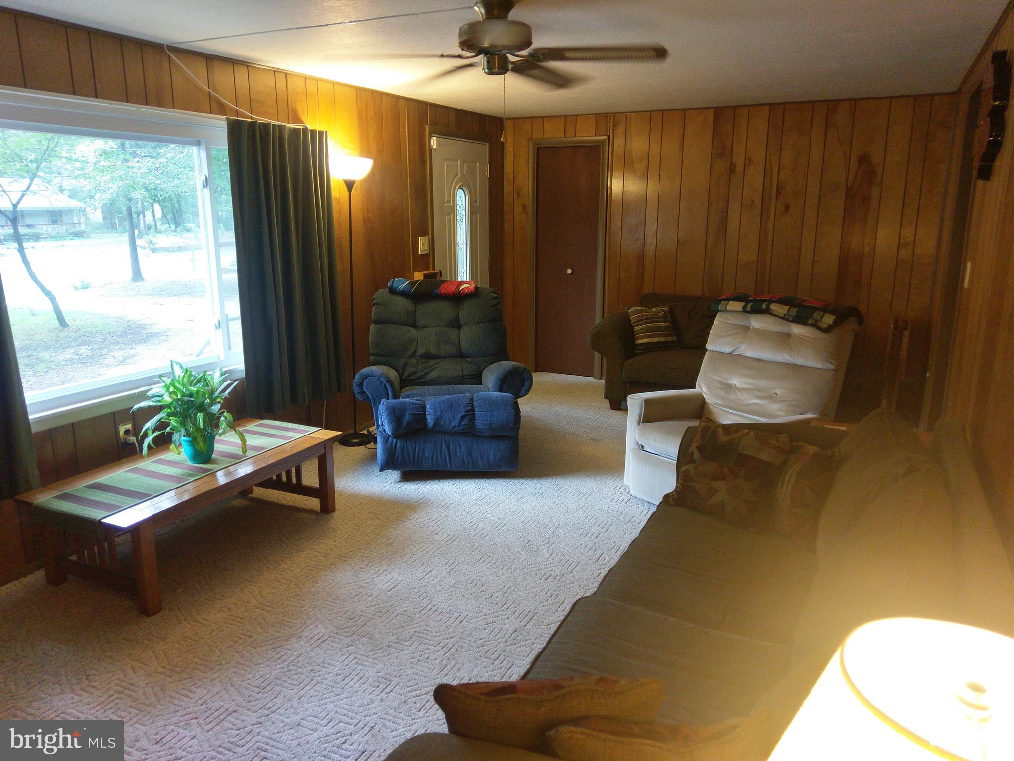 12820 Rousby Hall Road Lusby, MD 20657 - Photo 12 of 39 a living room with furniture and a large window