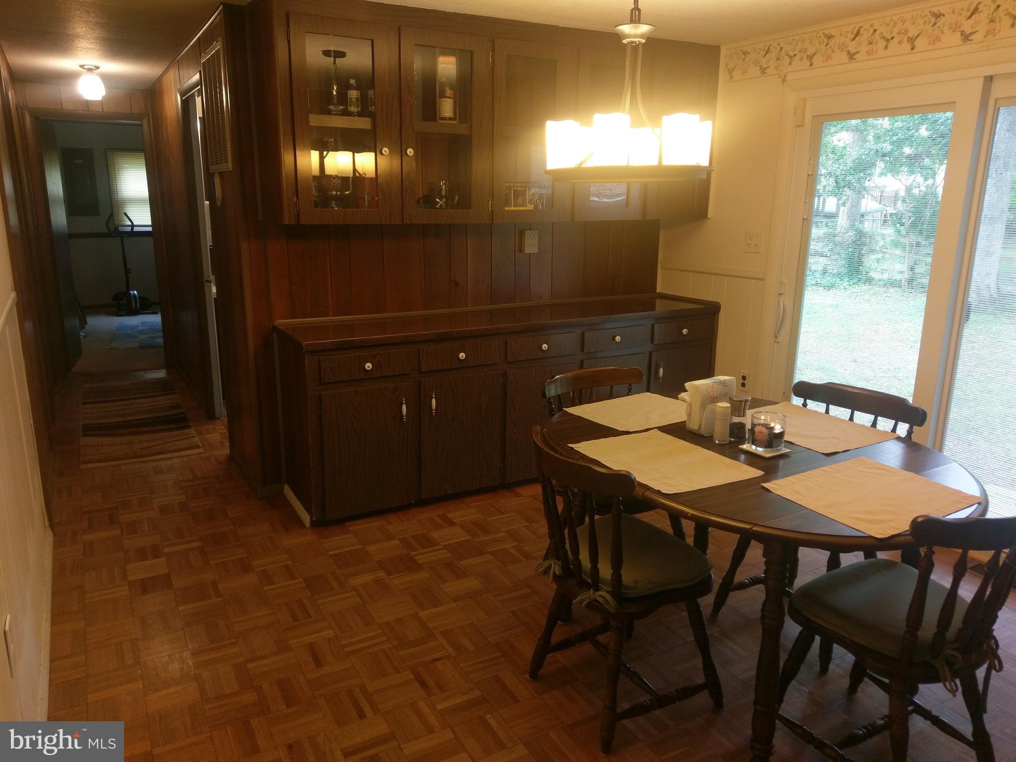 12820 Rousby Hall Road Lusby, MD 20657 - Photo 14 of 39 a dining room with a table and chairs