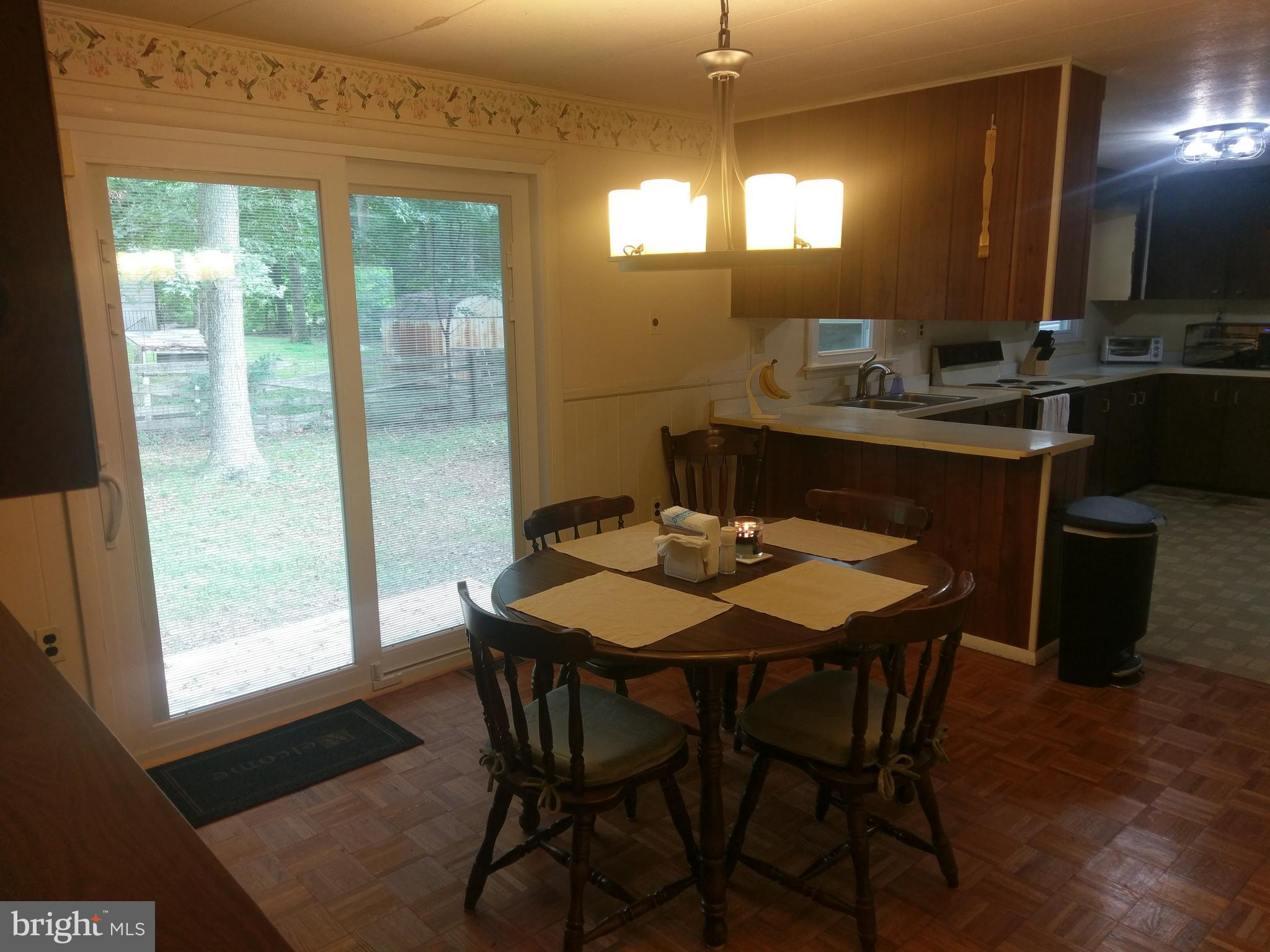 12820 Rousby Hall Road Lusby, MD 20657 - Photo 15 of 39 a view of a dining room with furniture and window
