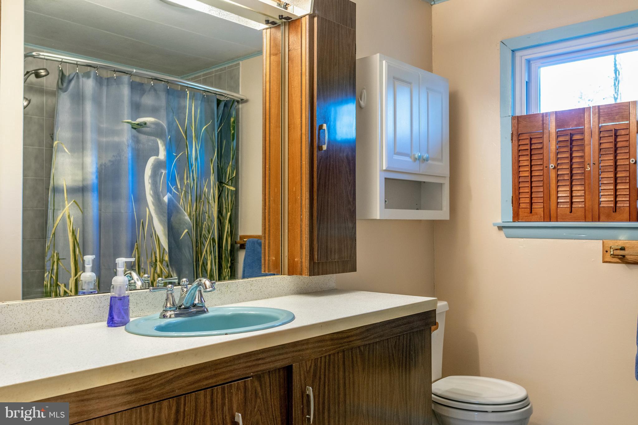 12820 Rousby Hall Road Lusby, MD 20657 - Photo 19 of 39 a bathroom with a granite countertop sink toilet and shower