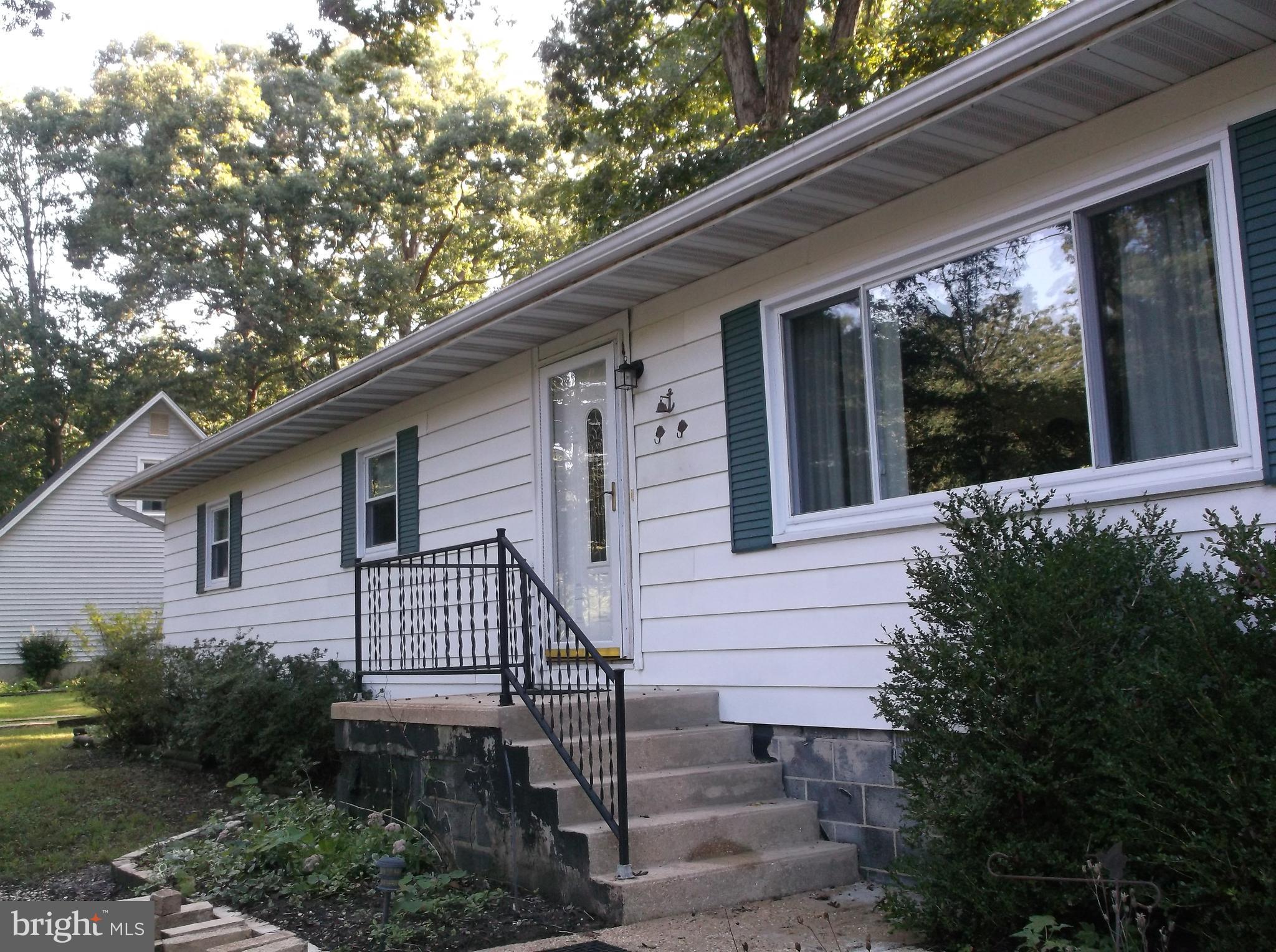 12820 Rousby Hall Road Lusby, MD 20657 - Photo 3 of 39 a front view of a house with garden