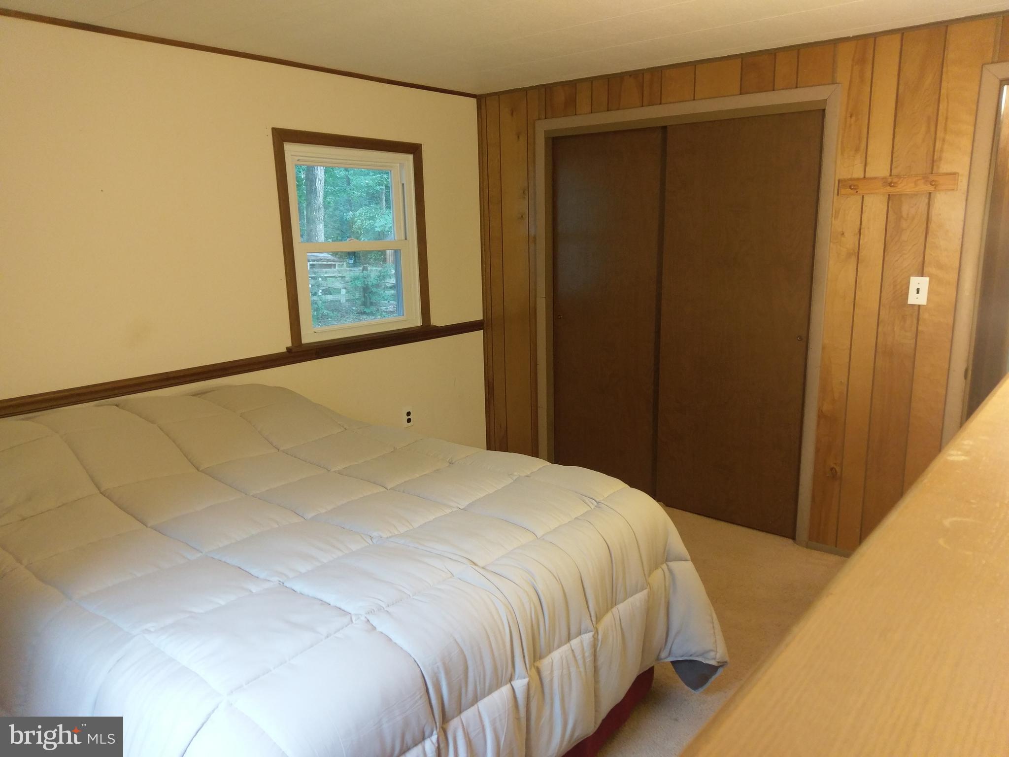 12820 Rousby Hall Road Lusby, MD 20657 - Photo 23 of 39 a bedroom with a bed and a window
