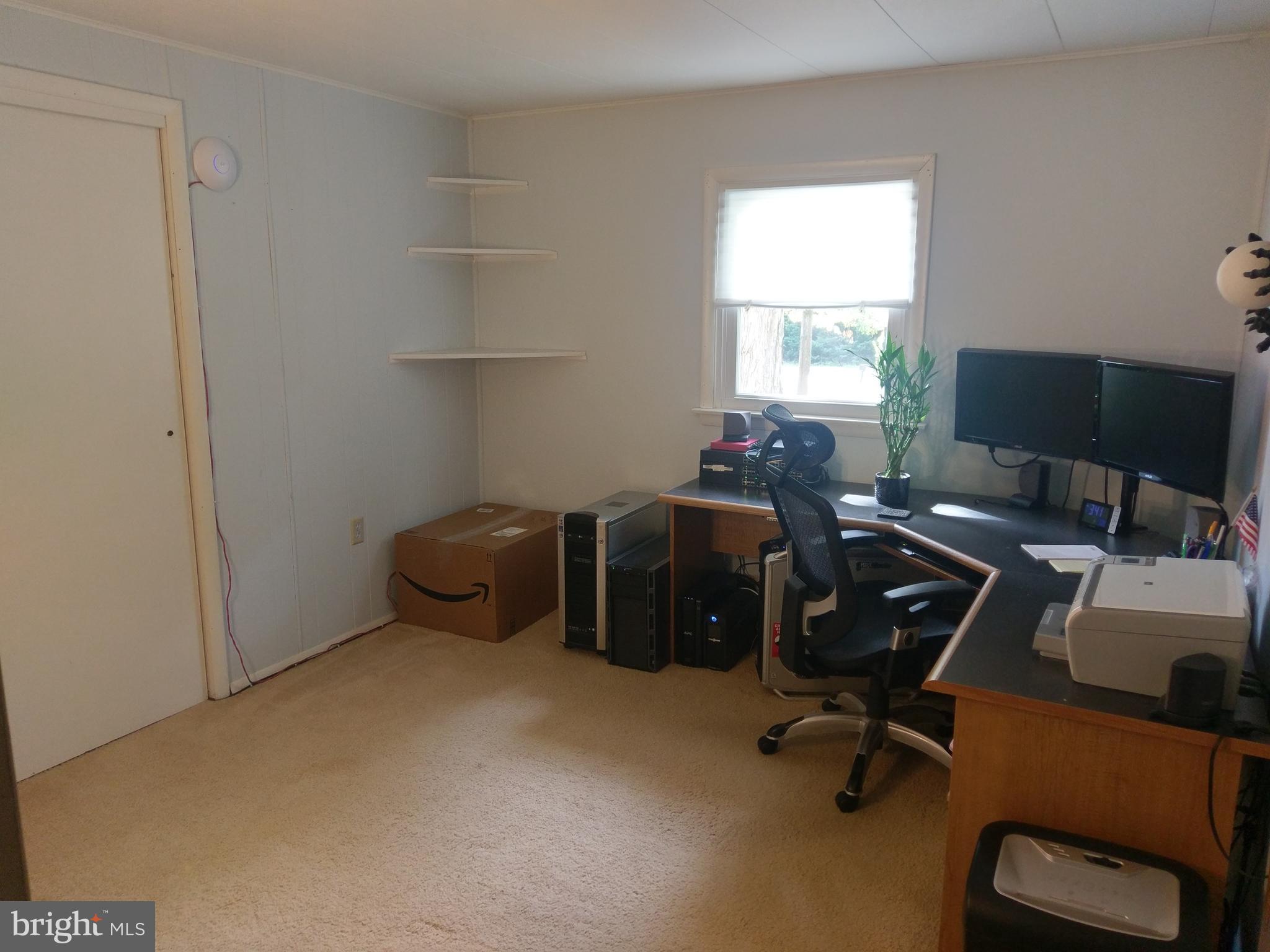 12820 Rousby Hall Road Lusby, MD 20657 - Photo 24 of 39 a view of a workspace with furniture and a window