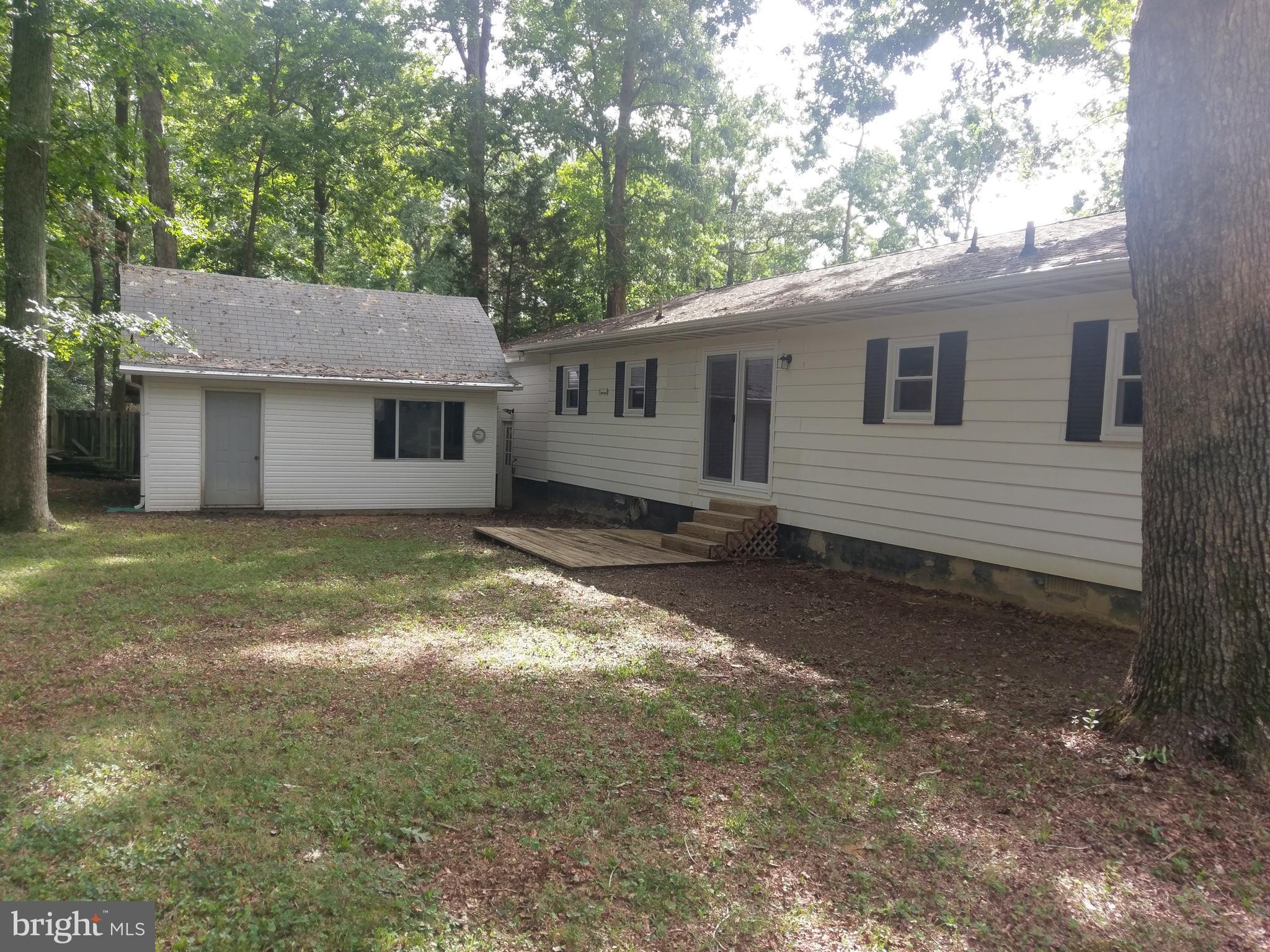12820 Rousby Hall Road Lusby, MD 20657 - Photo 4 of 39 a view of a house with a yard