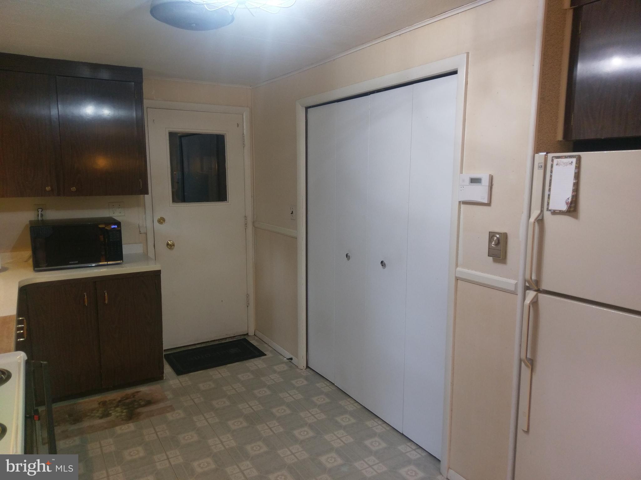 12820 Rousby Hall Road Lusby, MD 20657 - Photo 9 of 39 a view of kitchen with a refrigerator