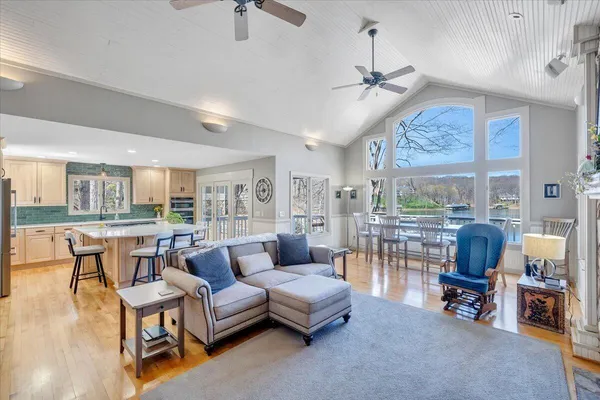 a kitchen with stainless steel appliances granite countertop a stove a refrigerator a sink a table and chairs