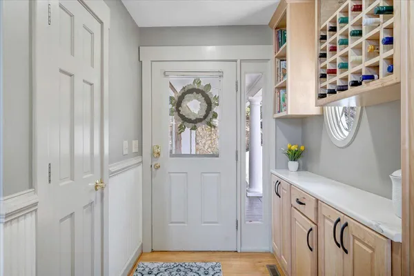 a living room with furniture a large window and wooden floor