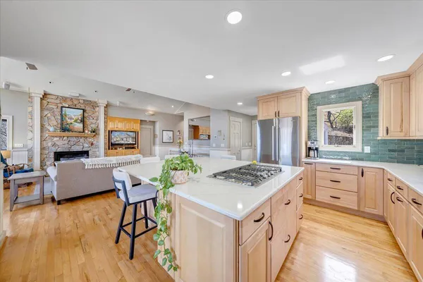 a living room with furniture and a kitchen view