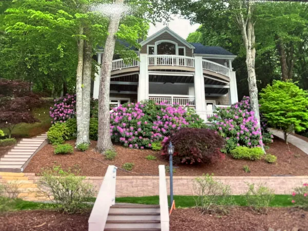 a view of a house with a yard from a fountain