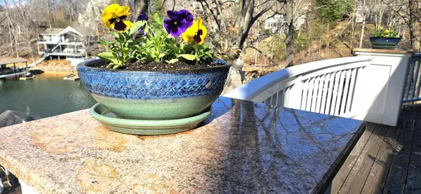 a large bedroom with a bed and wooden floor