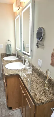 a swimming pool with outdoor seating and lake view