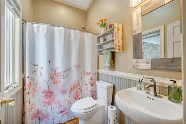 a view of a house with a wooden fence