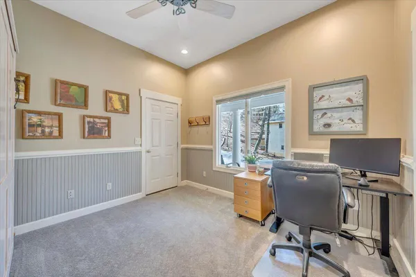 a front view of a house with a yard and potted plants
