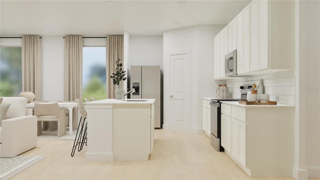 5108 Flaxleaf Street St. Cloud, FL 34772 - Photo 3 of 31 a kitchen with white cabinets and refrigerator