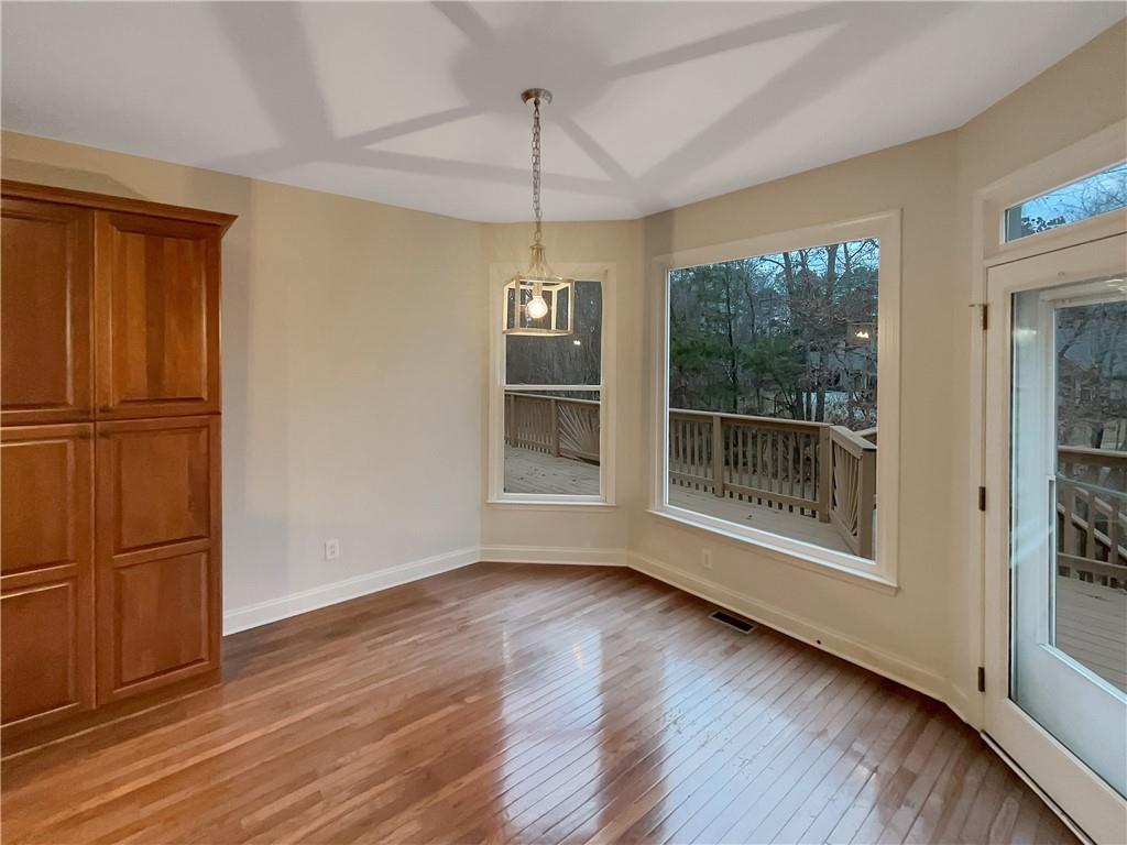 37 Ashdowne Way Acworth, GA 30101 - Photo 11 of 31 a view of an empty room with wooden floor and a window