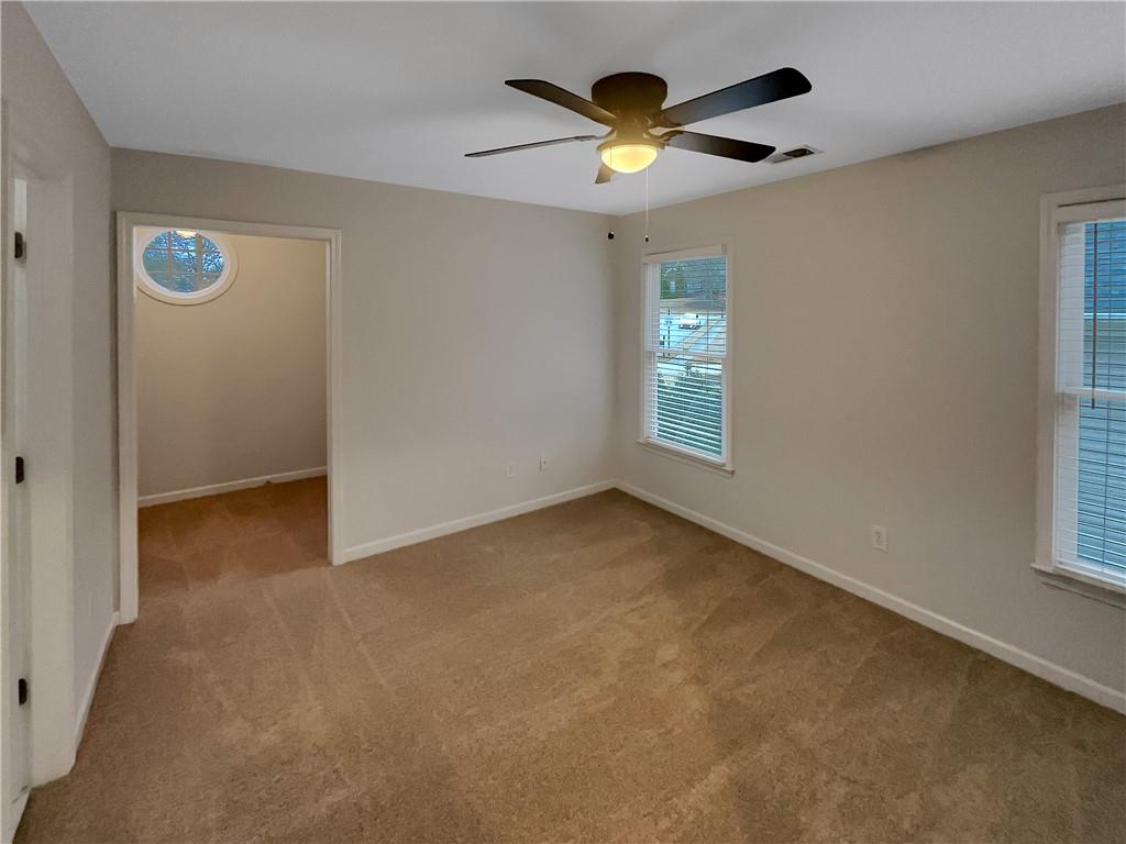 37 Ashdowne Way Acworth, GA 30101 - Photo 23 of 31 an empty room with a window and a ceiling fan