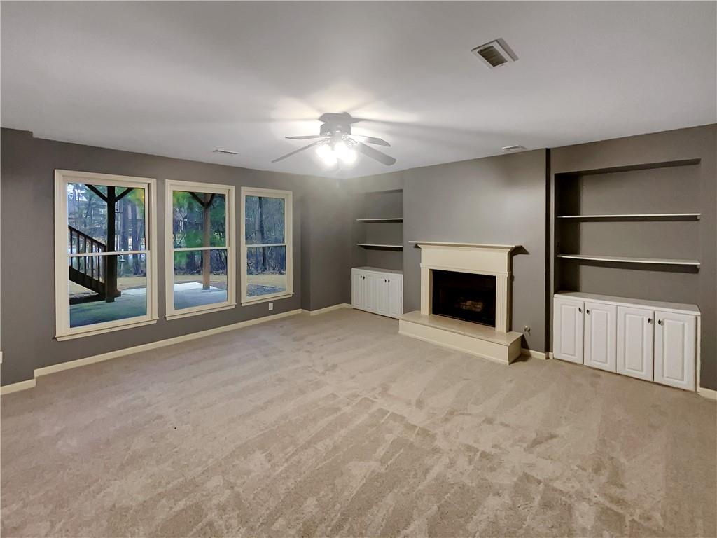 37 Ashdowne Way Acworth, GA 30101 - Photo 24 of 31 an empty room with a fireplace cabinet and windows
