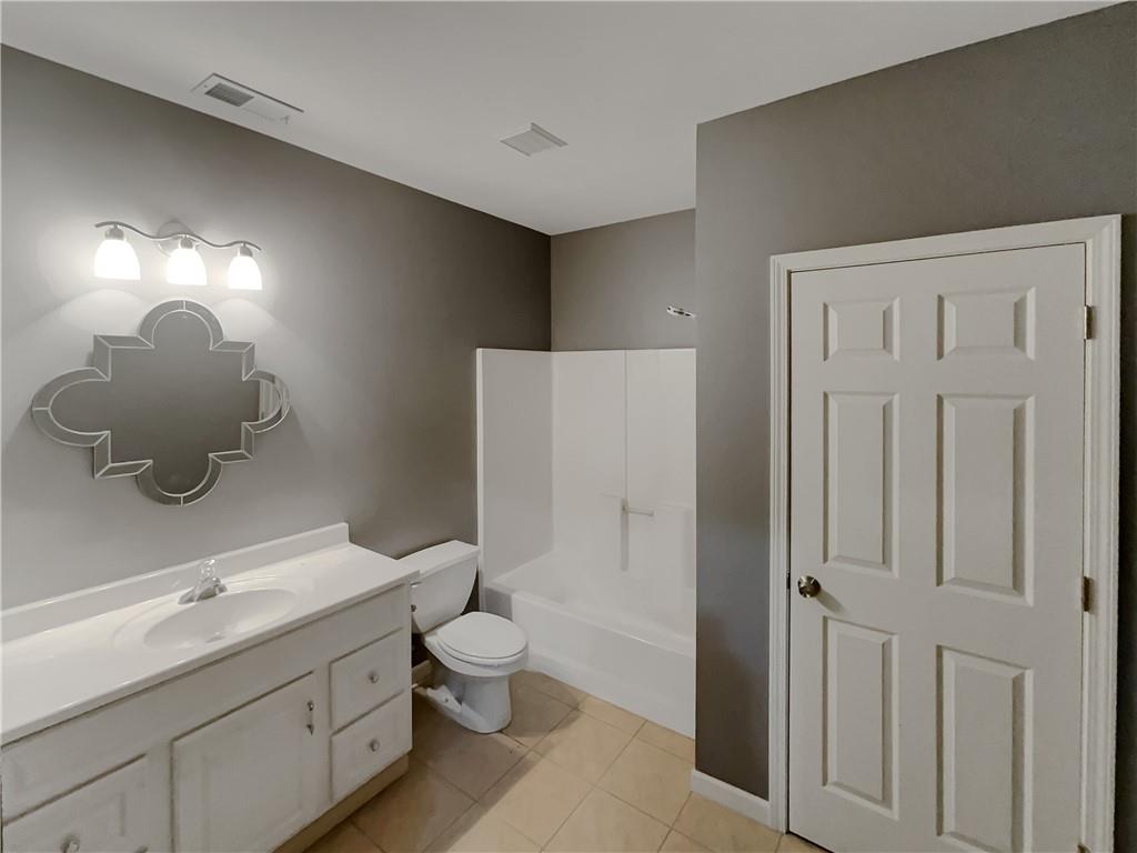 37 Ashdowne Way Acworth, GA 30101 - Photo 28 of 31 a bathroom with a toilet a sink and mirror