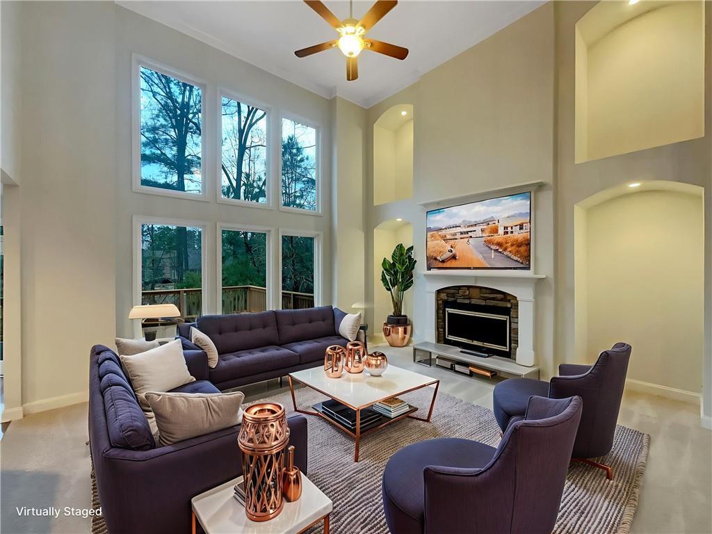 37 Ashdowne Way Acworth, GA 30101 - Photo 4 of 31 a living room with furniture a large window and a fireplace