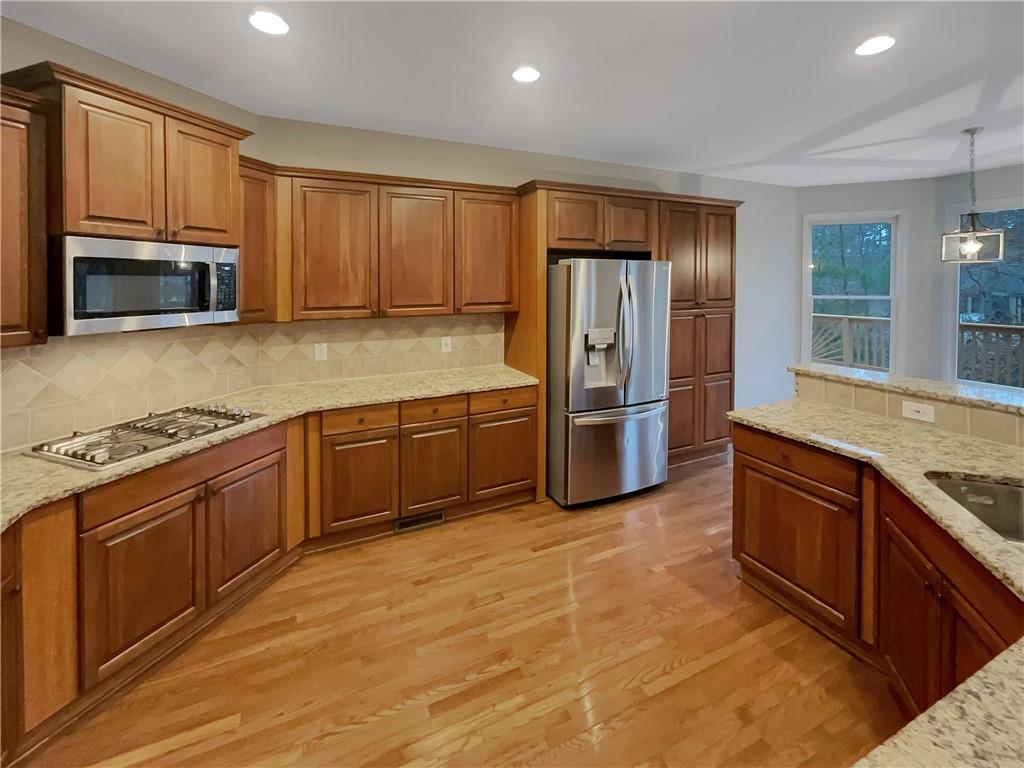 37 Ashdowne Way Acworth, GA 30101 - Photo 9 of 31 a kitchen with stainless steel appliances granite countertop a refrigerator a stove top oven a sink and dishwasher