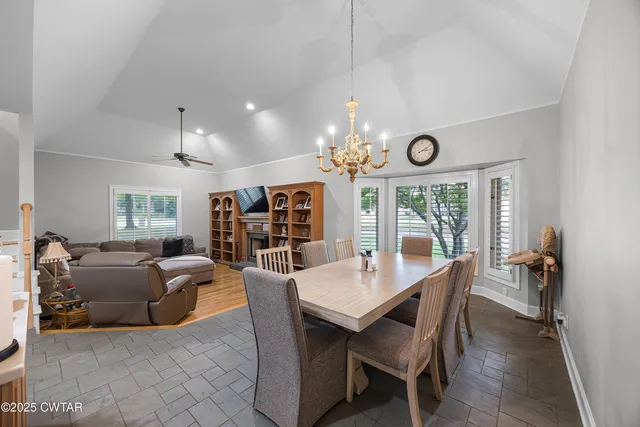 a living room with furniture and chandelier