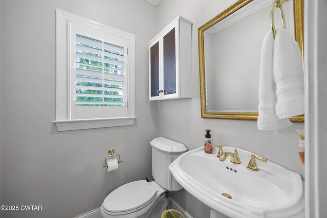 a living room with furniture and a baby crib