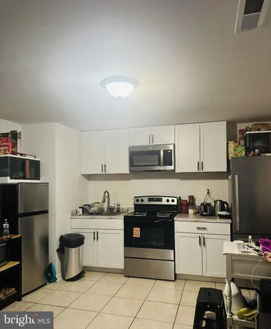 a kitchen with a stove top oven and cabinets