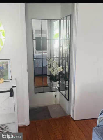 a view of a room that has a window and wooden floor