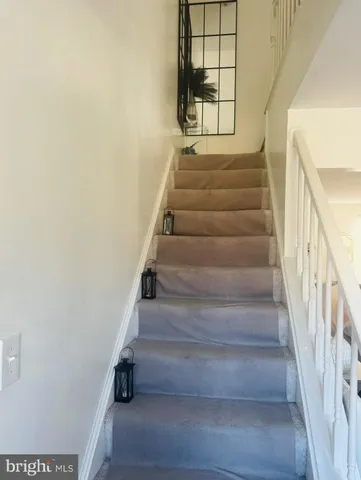 a front view of house and yard with beautiful flowers