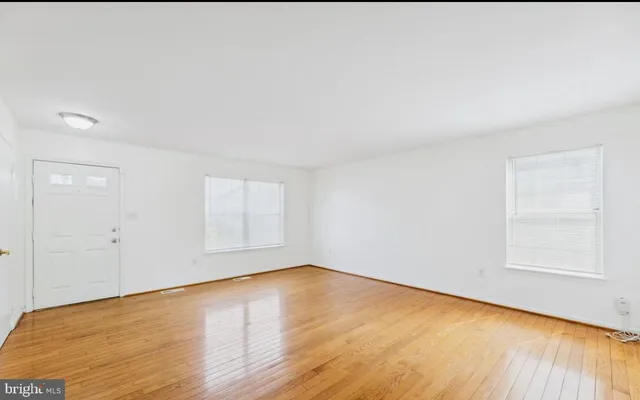 a view of a room with wooden floor and window