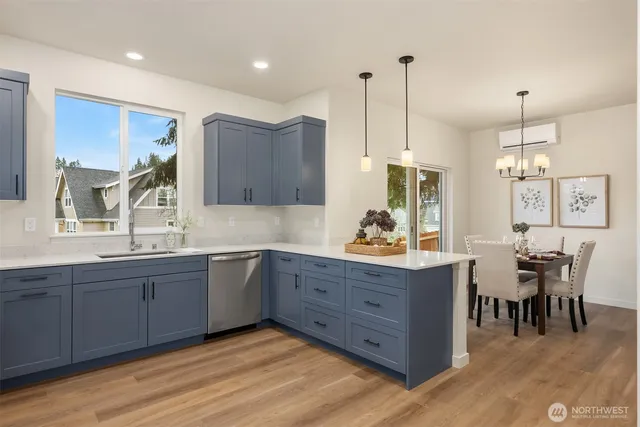 a kitchen with stainless steel appliances granite countertop sink stove top oven and cabinets