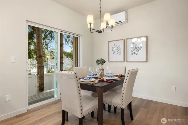 a view of a dining room with furniture window and wooden floor