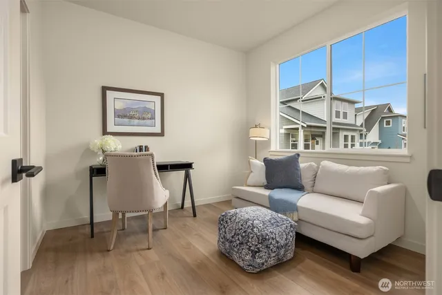 a living room with furniture a rug and a painting