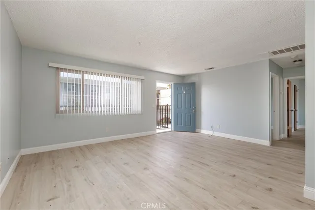 a kitchen with stainless steel appliances granite countertop a refrigerator a sink and a stove