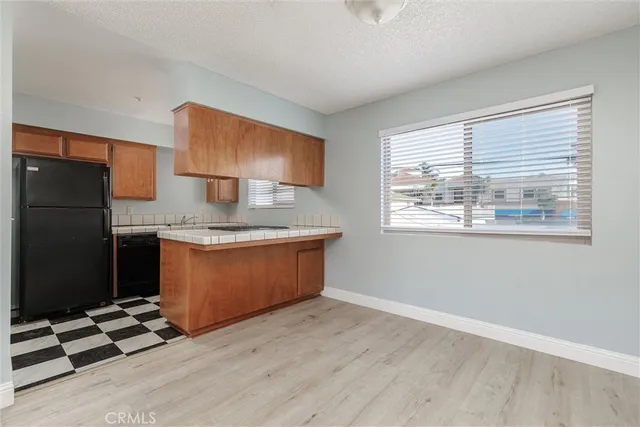 a kitchen with a stove a refrigerator and cabinets