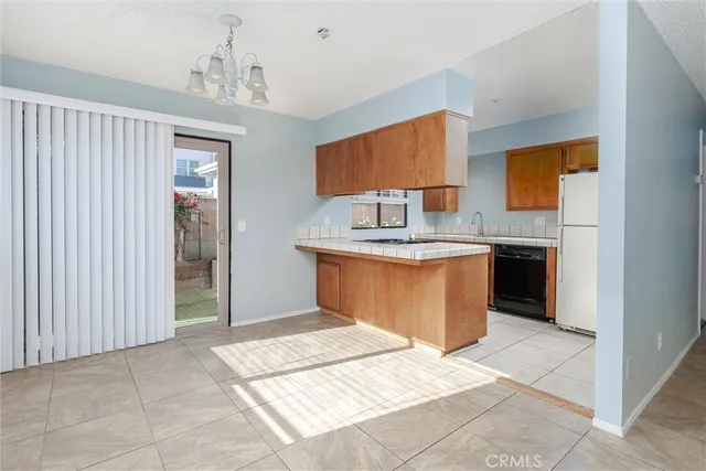 a kitchen with stainless steel appliances granite countertop a refrigerator a stove and a sink