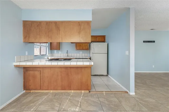 a kitchen with a sink stove top oven and cabinets