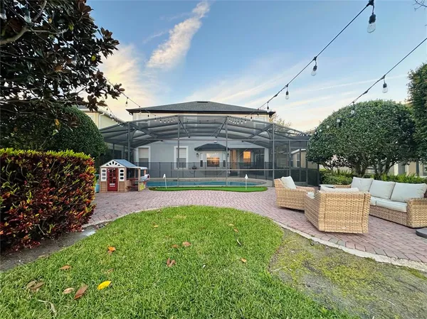 a view of house with swimming pool outdoor seating