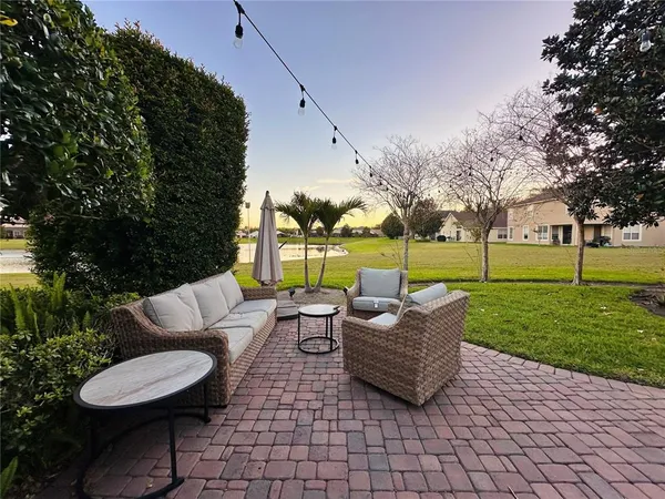 a view of a patio with couches and a fire pit