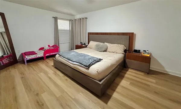 a bed sitting in a bedroom next to a window