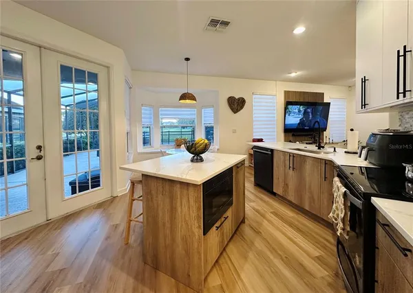 a kitchen with a sink a counter top space and stainless steel appliances