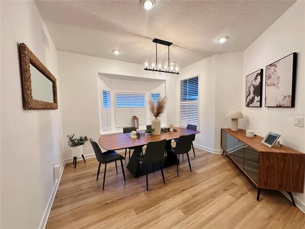 a view of a dining room with furniture window and wooden floor