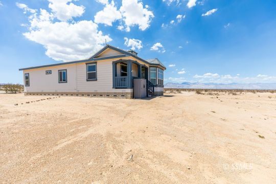 2014 South Brady Street Ridgecrest, CA 93555 - Photo 2 of 32 a front view of house with yard covered in snow