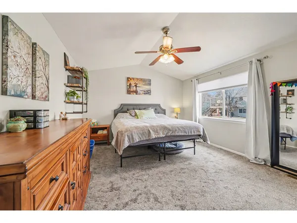 a spacious bedroom with a bed and a window