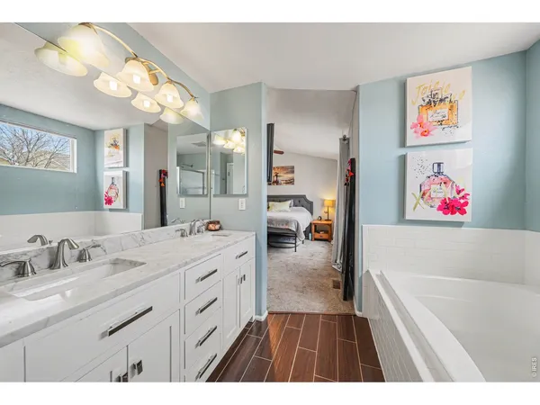 a bathroom with a sink a vanity a mirror and a shower