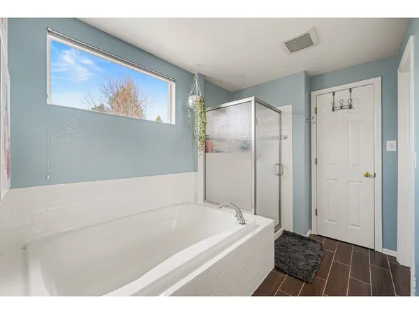 a bathroom with a bathtub and a shower